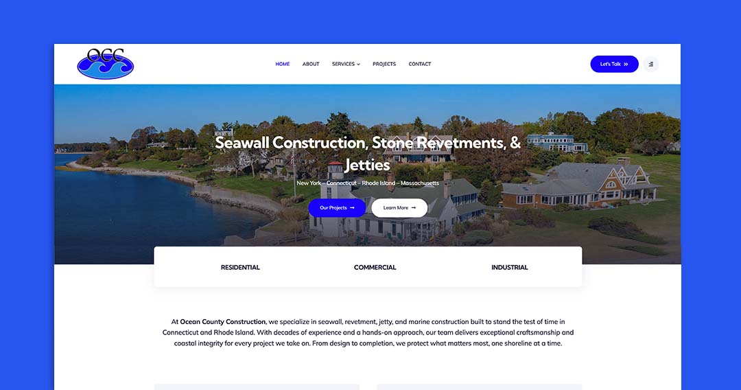 Aerial view of waterfront homes as the hero image, overlaid with the headline 'Seawall Construction, Stone Revetments, & Jetties' and a top navigation bar with a blue 'Let's Talk' button on the right.